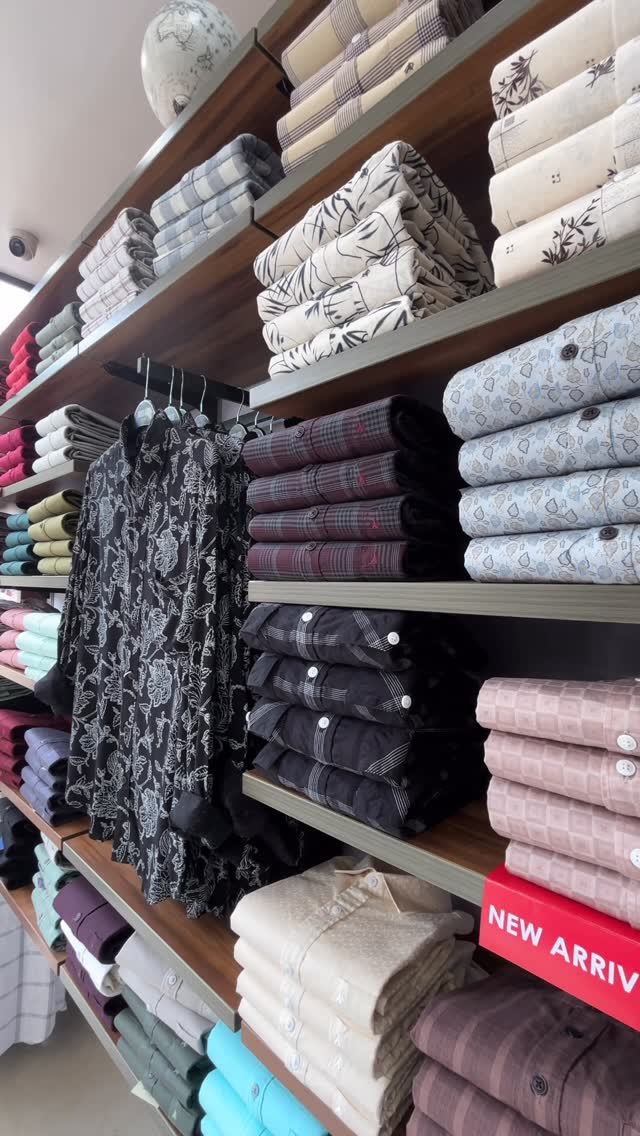 Wall of folded printed shirts in the United Kites store